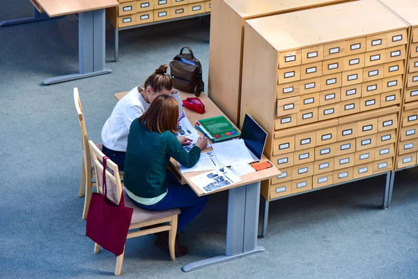 Students read books in the library