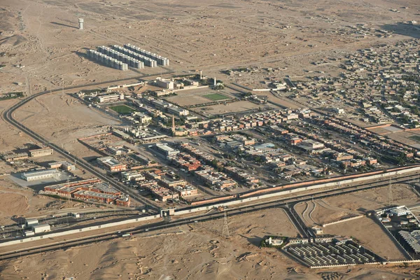 Desert city among mountains and sands, view from above