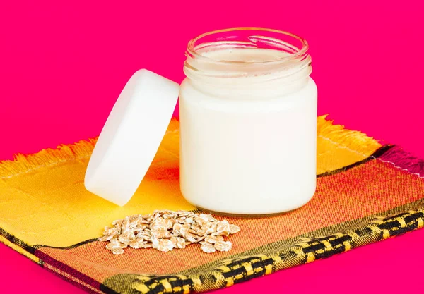 Jar with yogurt isolated on pink background. — Stock Photo, Image