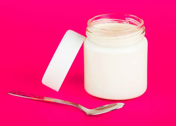 Jar with yogurt isolated on pink background. — Stock Photo, Image