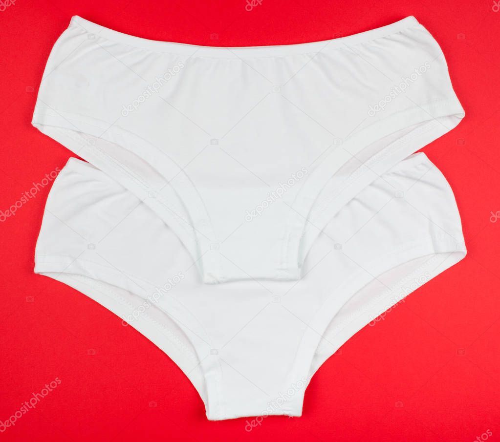 Women's cotton panties flowered isolated on red background.