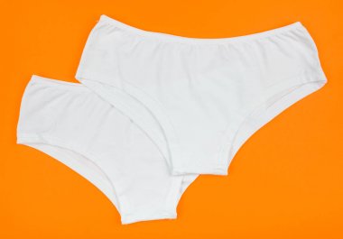 Kadın Pamuk külot üzerinde yalıtılmış turuncu arka plana çiçekli.