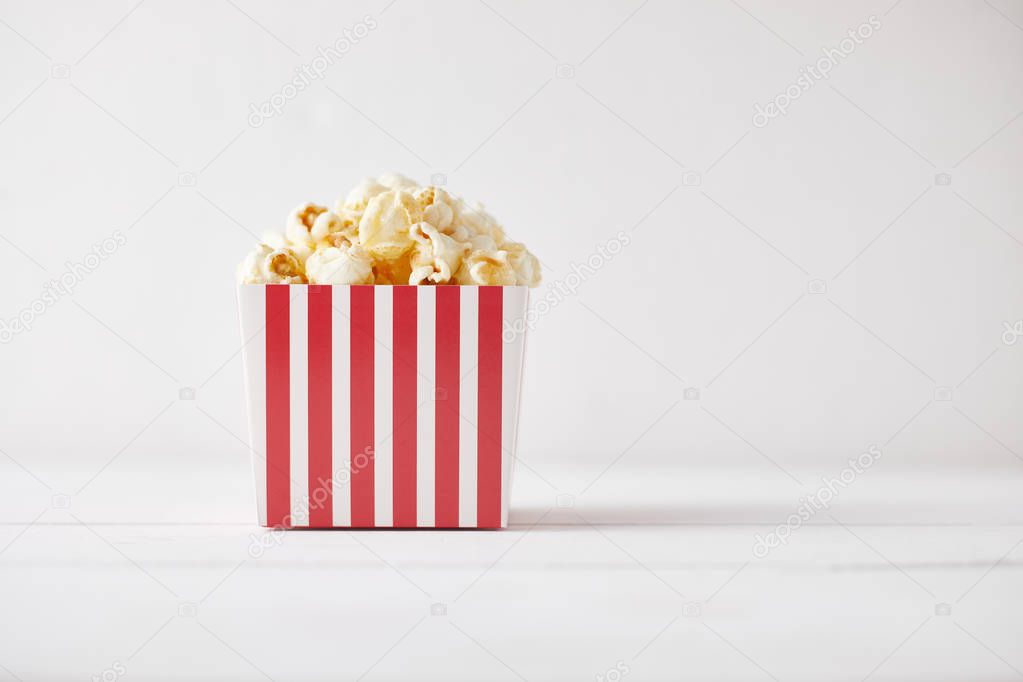 Full of tasty caramel popcorn in classic striped box