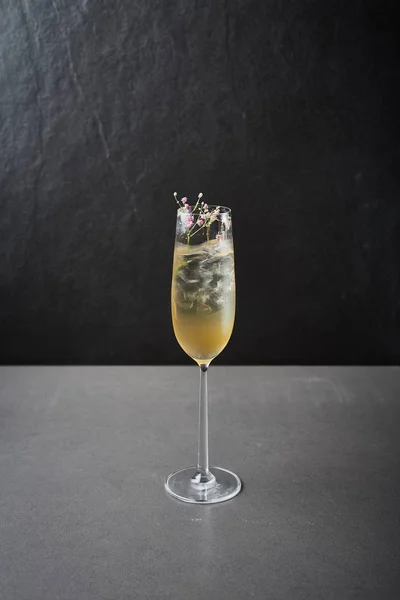 Lemon champagne cocktail on dark stone table, With space for you