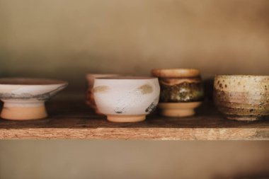 Çamur çömlek seramik ürünleri atölyedeki raflarda kurur.