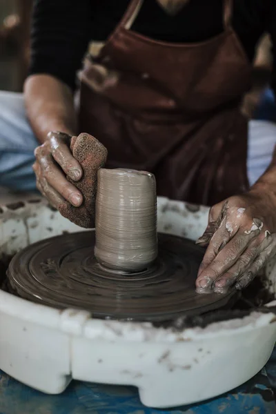 Hands of craftsman artist working on pottery wheel. — ストック写真