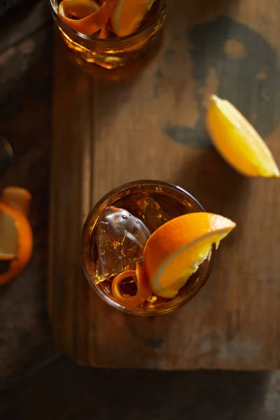 Tasty alcoholic old fashioned cocktail with orange slic