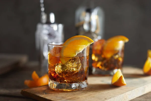 Tasty alcoholic old fashioned cocktail with orange slic