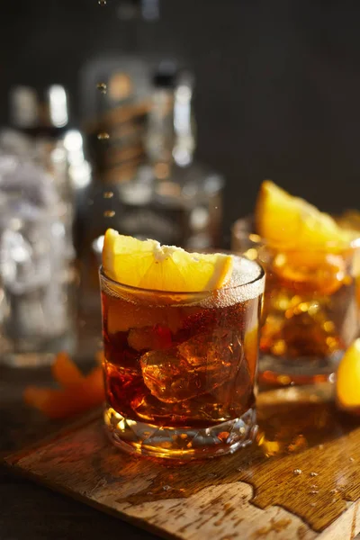 Tasty alcoholic old fashioned cocktail with orange slic