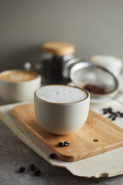 kahve fincanı ve masada kahve çekirdekleri