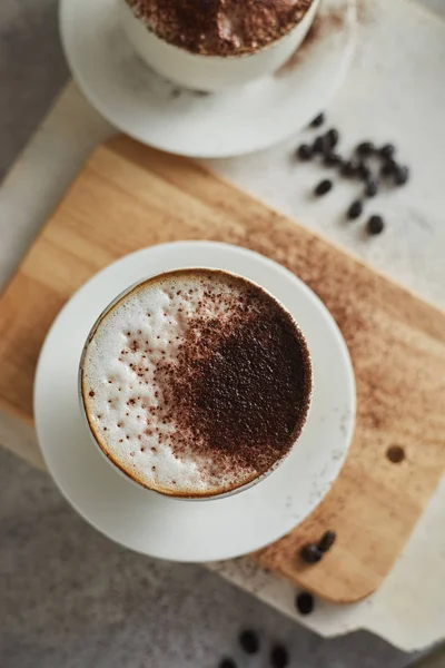 Taza de café y granos de café en la mesa — Foto de Stock