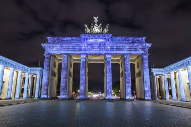 Günbatımı sırasında Berlin'de ışıklı Brandenburg Kapısı (Brandenburger Tor)