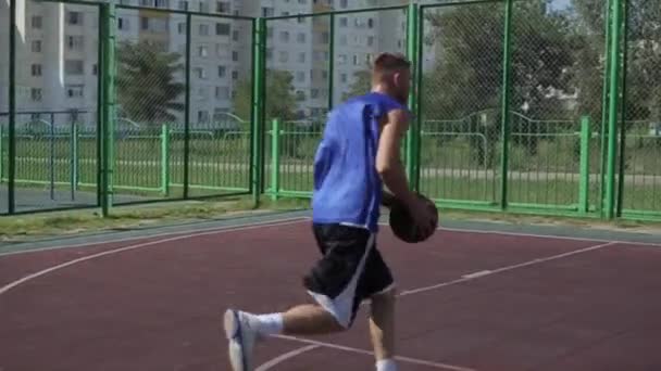 Bobruisk, Belarus - 12 augustus 2019: slow motion. Happy basketbalspeler leiden en passeren bal tijdens straat basketbal spel — Stockvideo