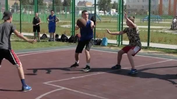 Bobruisk, Belarus - 12 augustus 2019: slow motion. Happy basketbalspeler leiden en passeren bal tijdens straat basketbal spel — Stockvideo