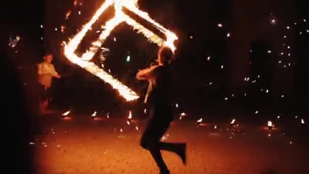 Minszk, Fehéroroszország - augusztus 8, 2019: Man spins burning cube as a part of fire show — Stock videók