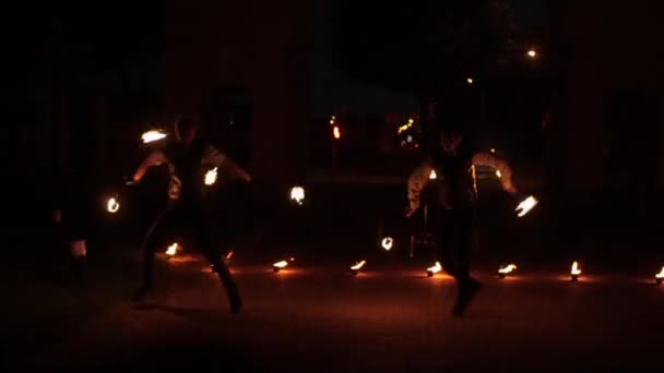 Mińsk, Białoruś - 8 sierpnia 2019: Dwóch pięknych żonglerów pożarowych tańczących z fanami ognia — Wideo stockowe