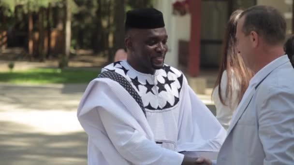 Mogilev, Belarus - July 11, 2019: People from Russia or Belarus greeting two people from Nigeria — Stok video