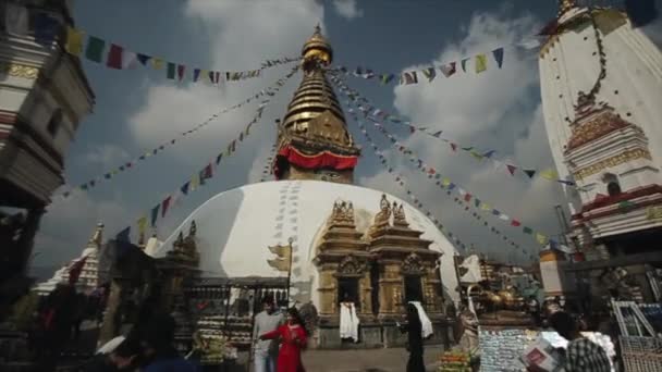 Kathmandu, Nepal - 14 November 2019: Buddhist Swayambunath Tempel in Kathmandu Nepal outside view. Flying prayer flags. Crowd in the background. — стокове відео