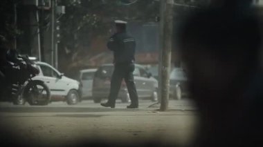 Kathmandu, Nepal - 14 November 2019: Nepalese traffic police, working, regulating busy chaotic road, street in Kathmandu, Nepal.