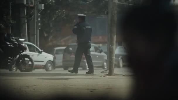 Kathmandu, Nepal - 14 November 2019: Nepalese traffic police, working, regulating busy chaotic road, street in Kathmandu, Nepal. — Stock video
