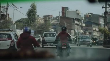 Kathmandu, Nepal - 15 November 2019: Nepalese people crossing busy street, road in Kathmandu, Nepal. View from a car.