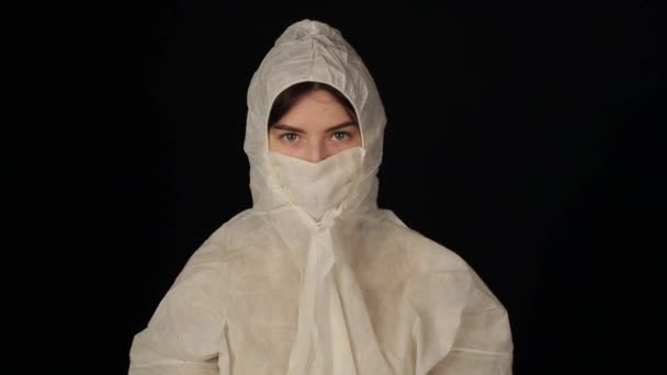 Caucasian girl with beautiful eyes in protective medocal suit costume looking at the camera. Coronavirus. COVID-19 — Stock Video