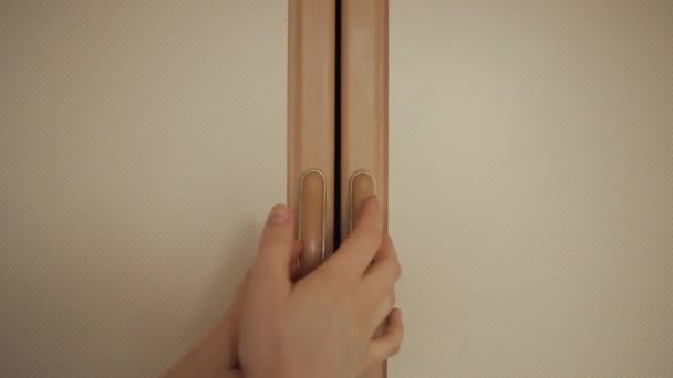 The girl opens a cupboard in the kitchen where there are spices in glass jars and takes one. Close-up — Stock Video