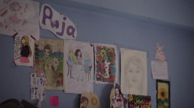 Katmandu, Nepal - 22 Kasım 2019: Çocuk resimleri odanın duvarında asılı. Odanın mavi duvarında farklı çocukların güzel çizimleri asılı.