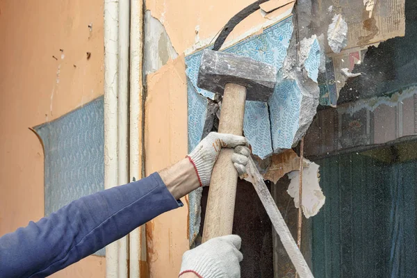 O martelo construtor quebra divisórias antigas no apartamento — Fotografia de Stock
