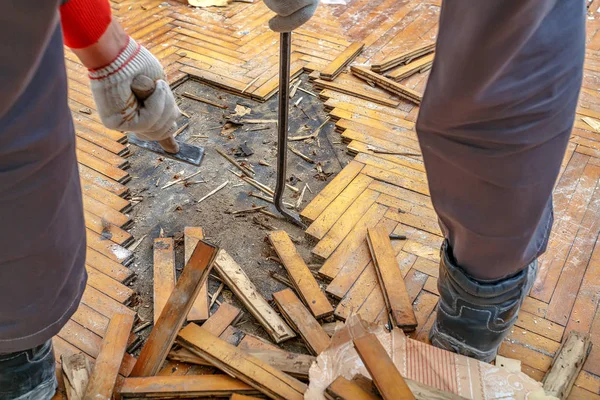 El trabajador desmonta el suelo de parquet —  Fotos de Stock