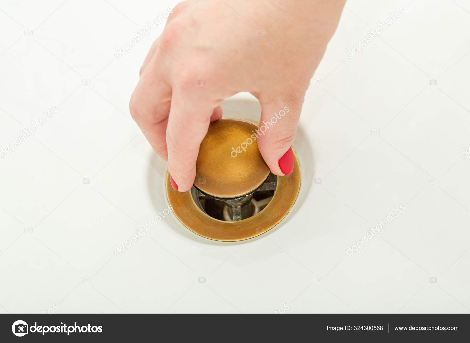 Female hand holds bathtub drain plug Stock Photo by ©RokaB 324300568