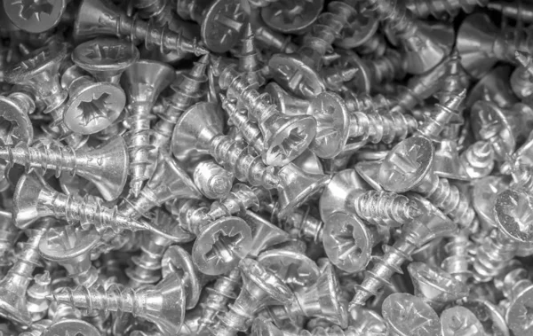 Small shiny silver screws. Background — Stock Photo, Image