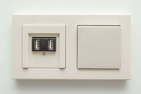 Multifunction outlet with an white electrical light switch with — Stock Photo, Image