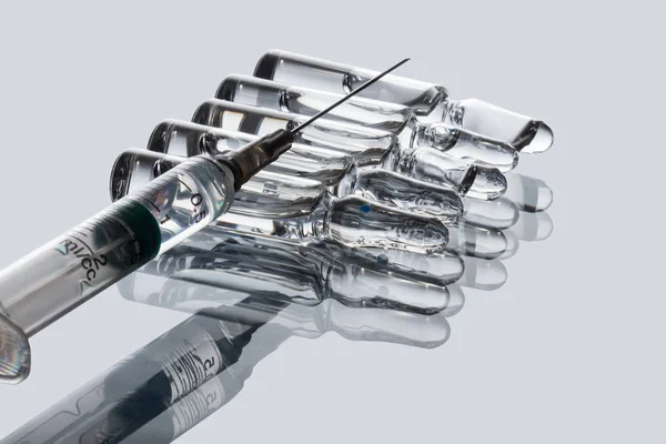 Medical ampoules and syringe — Stock Photo, Image