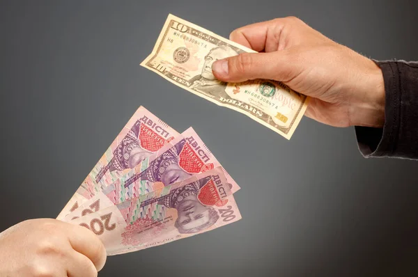 Hands exchange hryvnia and dollars — Stock Photo, Image