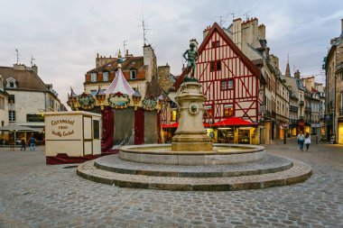 The Francois-Rude Square and the wine maker statue, with a carou
