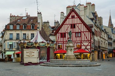 The Francois-Rude Square and the wine maker statue, with a carou