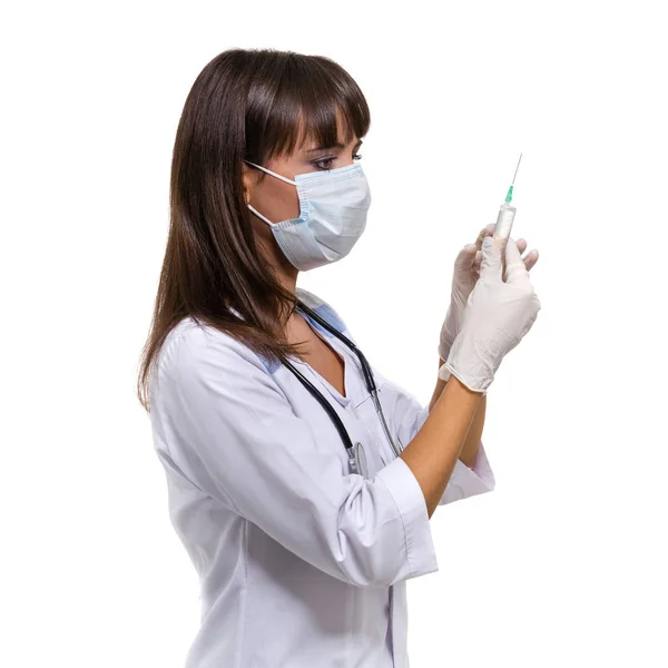 Doctor or nurse in face mask and lab coat holding syringe. Isolated on white. — Stock Photo, Image