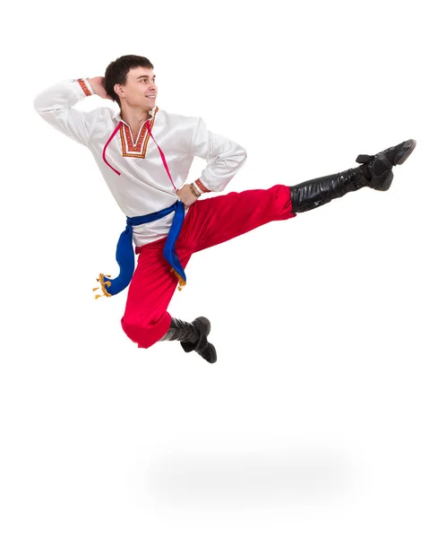 Молодий чоловік в народному костюмі, стрибає проти ізольованого білого кольору з копійкою Ліцензійні Стокові Зображення