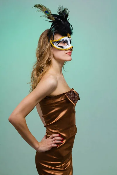 Carnival dancer woman wearing a mask posing on green — Stock Photo, Image