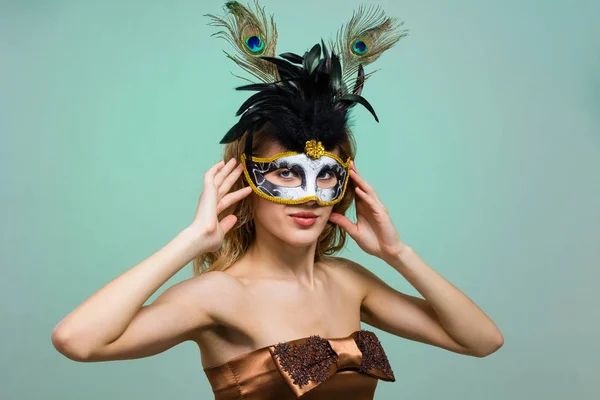 Carnival dancer woman wearing a mask posing on green — Stock Photo, Image