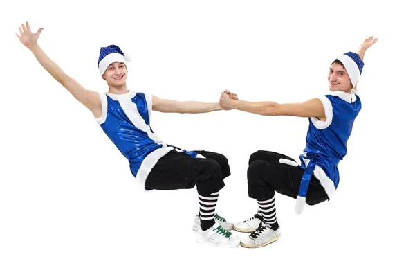 Dwóch mężczyzn Christmas w niebieskie stroje santa taniec przed biały na białym tle w pełnej długości. — Zdjęcie stockowe
