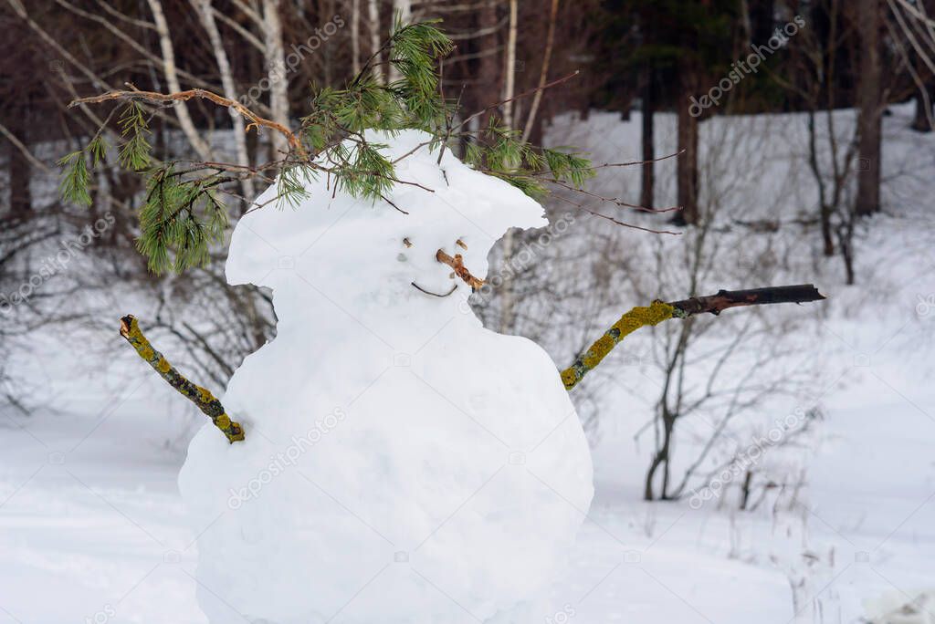 Merry snowman in the winter forest, Russia.