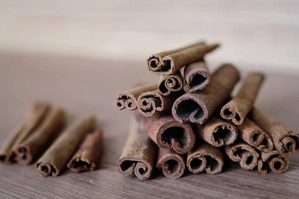 Cinnamon sticks on a wooden table top, selective focus.