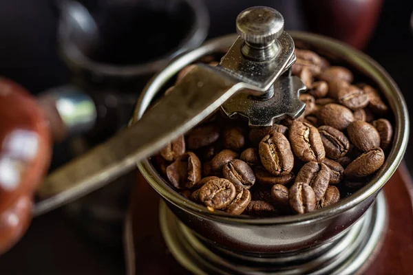 Coffee beans in a manual coffee grinder, selective focus.