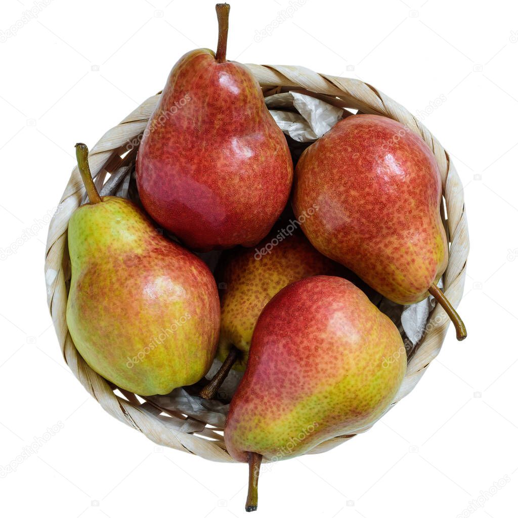 Top view yellow and red pears in a wicker basket, isolated on white background.