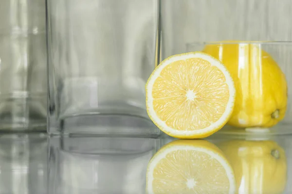 Half a lemon on the background of glassware, selective focus.