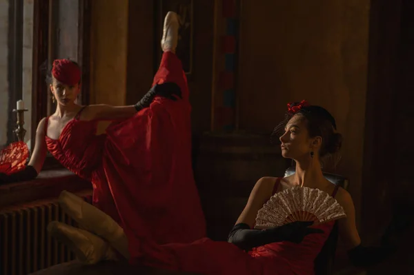 Two young and beautiful ballerinas in red dresses. Ballerina project. Karmen.