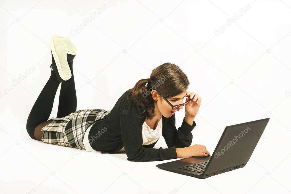 Girl lying on the floor with a laptop