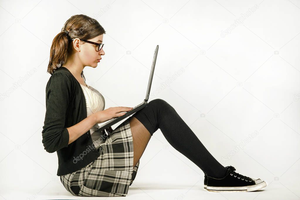 The girl with glasses working on a laptop
